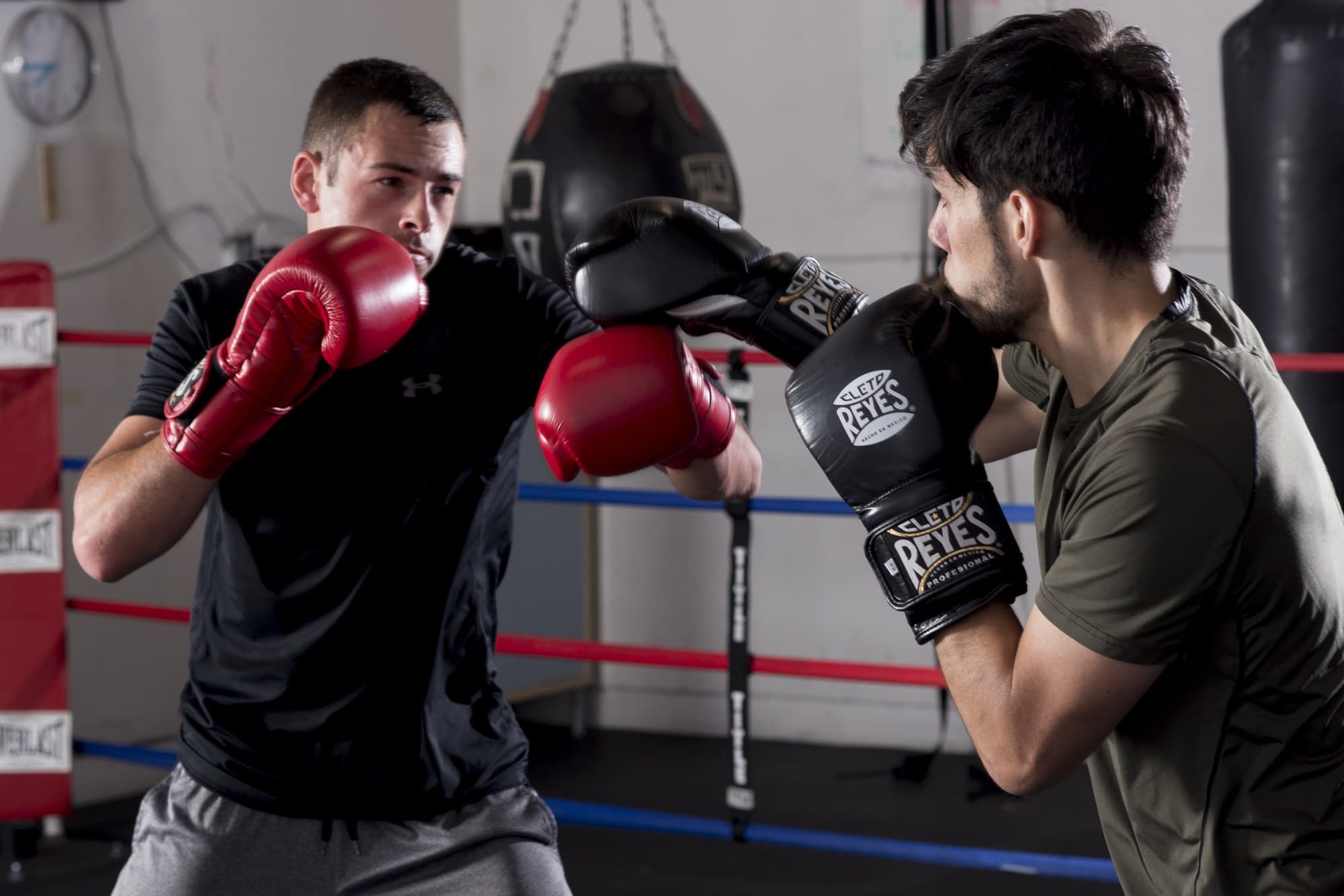 Two members trading punches in the ring during a group class at Ballard Barbell and Boxing Club